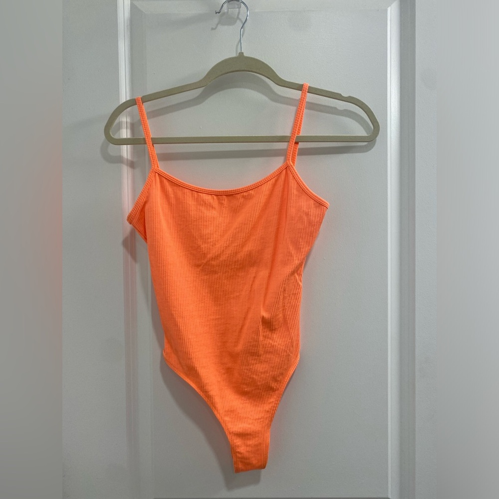 Super cute super SOFT and stretchy bodysuit. Mush more neon then in the picture